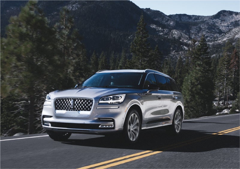 A 2023 Lincoln Aviator® Grand Touring SUV being driven on a winding road to demonstrate the capabilities of all-wheel drive | Napleton River Oaks Lincoln in Calumet City IL