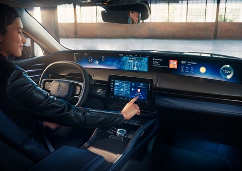 The driver of a 2024 Lincoln Nautilus® SUV interacts with the center touchscreen. | Napleton River Oaks Lincoln in Calumet City IL