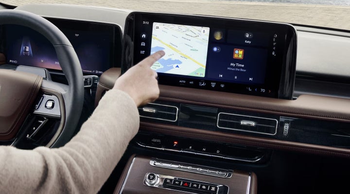 A person is tapping the center display touchscreen of a 2026 Lincoln Aviator® SUV. | Napleton River Oaks Lincoln in Calumet City IL