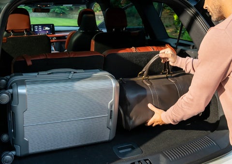 A man loads luggage into the rear of a 2026 Lincoln Aviator® SUV through the opened rear liftgate. | Napleton River Oaks Lincoln in Calumet City IL
