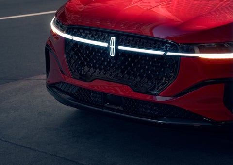 The available front LED light bar and center Lincoln Star logo glow at dusk. | Napleton River Oaks Lincoln in Calumet City IL