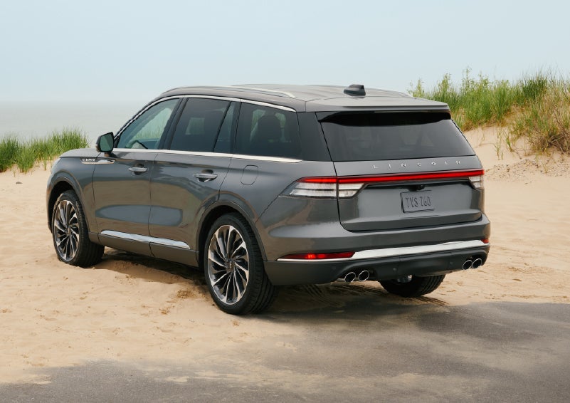 A 2027 Lincoln Aviator® SUV is parked next to sand dunes. | Napleton River Oaks Lincoln in Calumet City IL