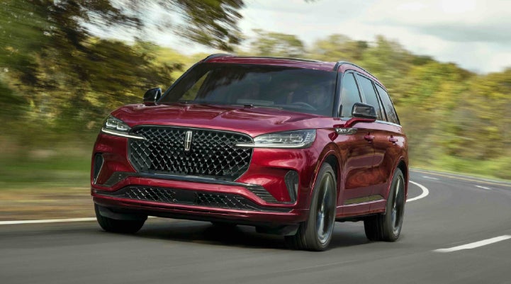 A 2027 Lincoln Aviator® SUV is being driven on a country road | Napleton River Oaks Lincoln in Calumet City IL