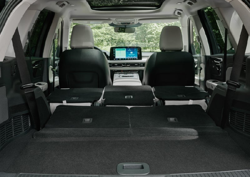A rear to front view of the interior of a 2027 Lincoln Aviator® Black Label™ SUV shows the third and second rows folded flat | Napleton River Oaks Lincoln in Calumet City IL