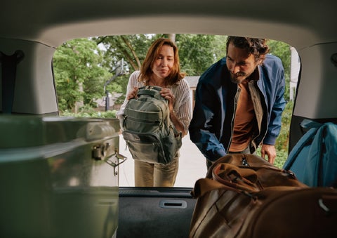 A couple loads luggage into the rear of a 2027 Lincoln Aviator® Black Label™ SUV..e 202 | Napleton River Oaks Lincoln in Calumet City IL