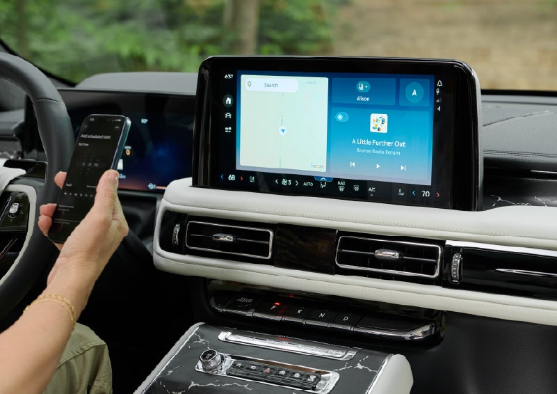 A person pairs thier phone with the center touchscreen of a 2027 Lincoln Aviator® Black Label™ SUV | Napleton River Oaks Lincoln in Calumet City IL